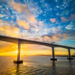 Morning Sunrise Peeking From Behind a Bridge Pier
