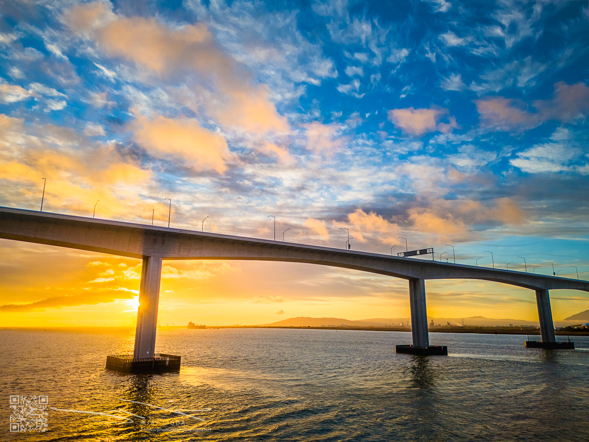 Morning Sunrise Peeking From Behind a Bridge Pier