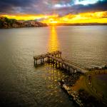 Rays of Sunset Broken Into Shadows Under a Pier