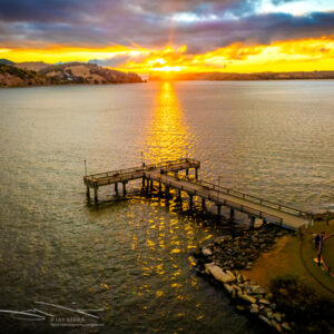Rays of Sunset Broken Into Shadows Under a Pier