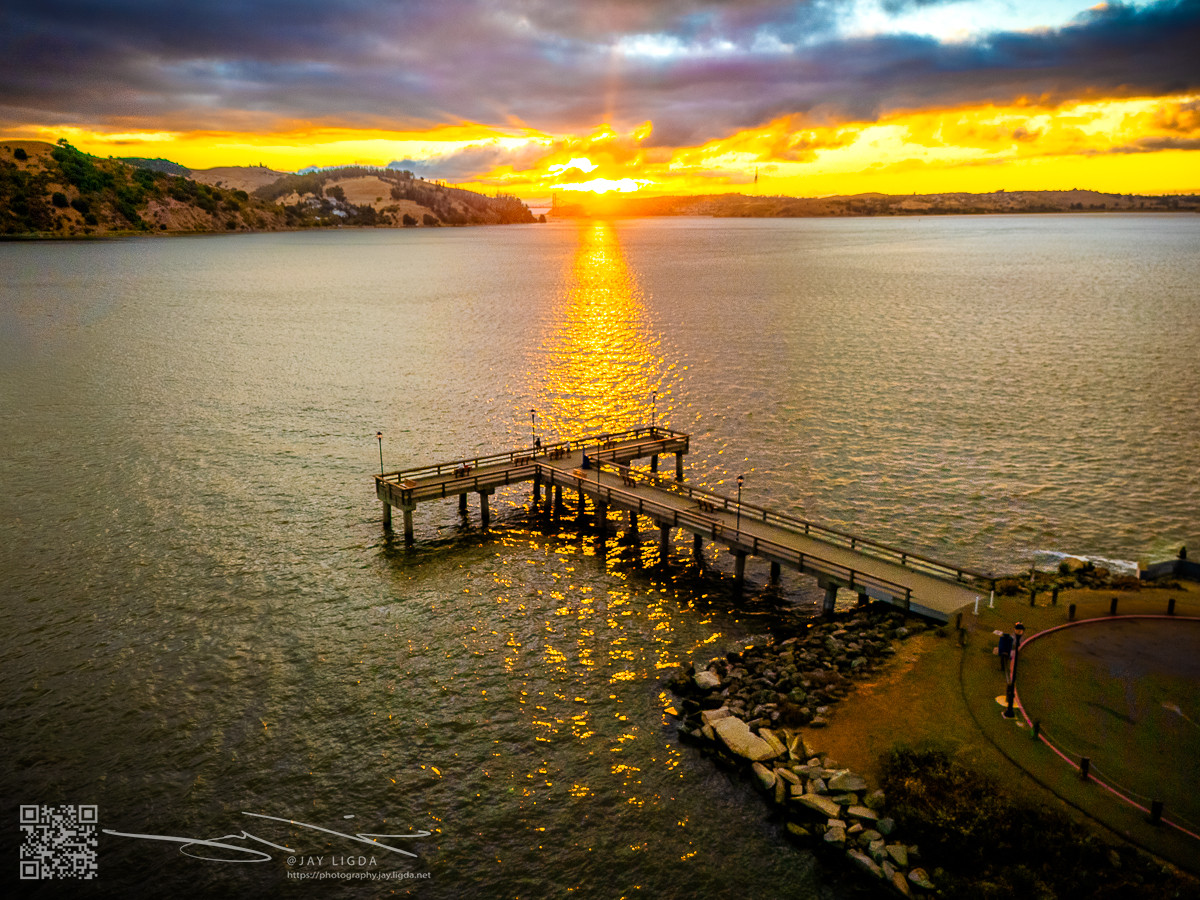 Rays of Sunset Broken Into Shadows Under a Pier