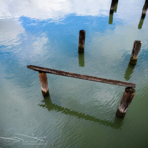 Blue Sky Reflects Calm Waters and Piers