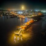 Full Mooon Rise Behind Lighted Fishing Pier