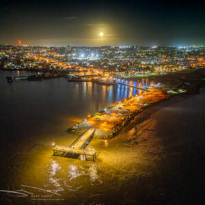 Full Mooon Rise Behind Lighted Fishing Pier
