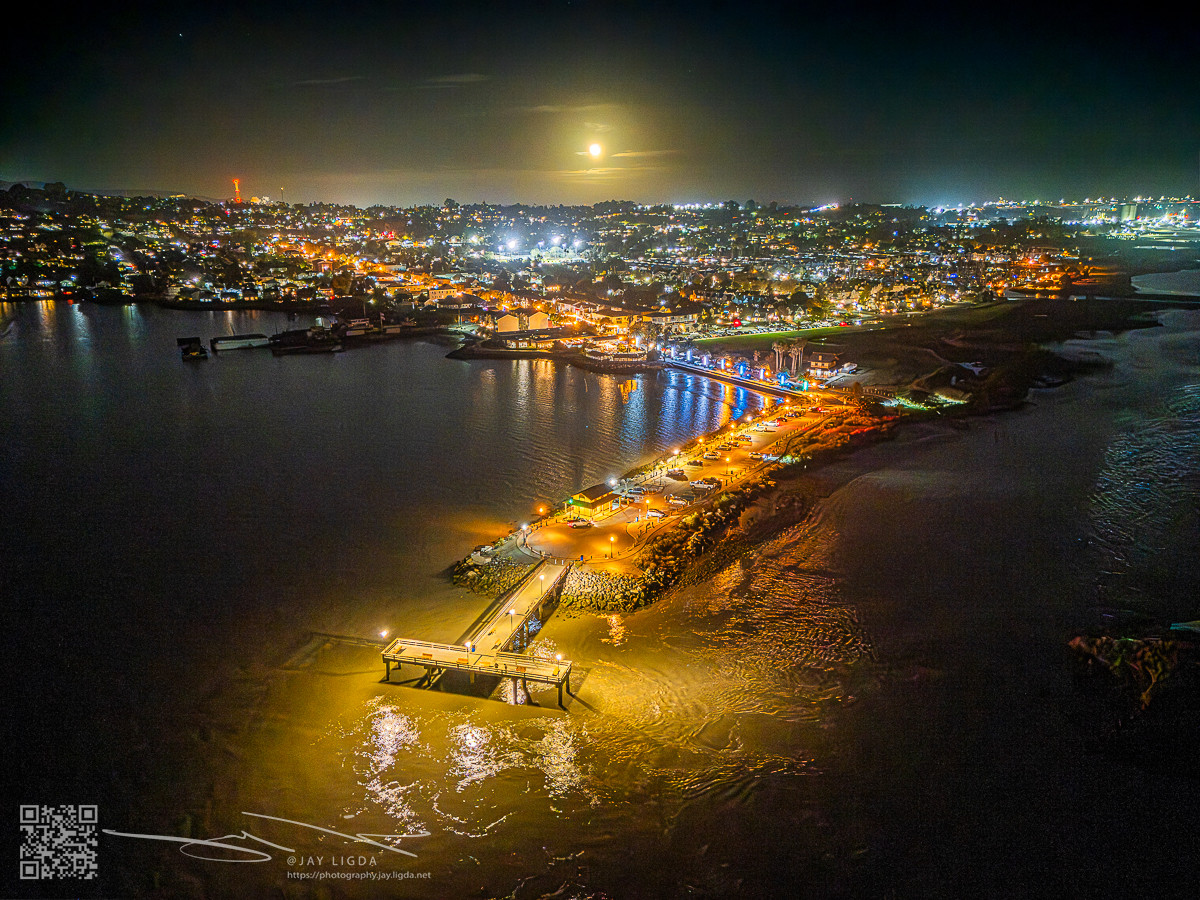 Full Mooon Rise Behind Lighted Fishing Pier